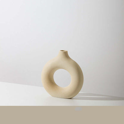 Off-white ceramic vase with circular hole, minimal spherical form