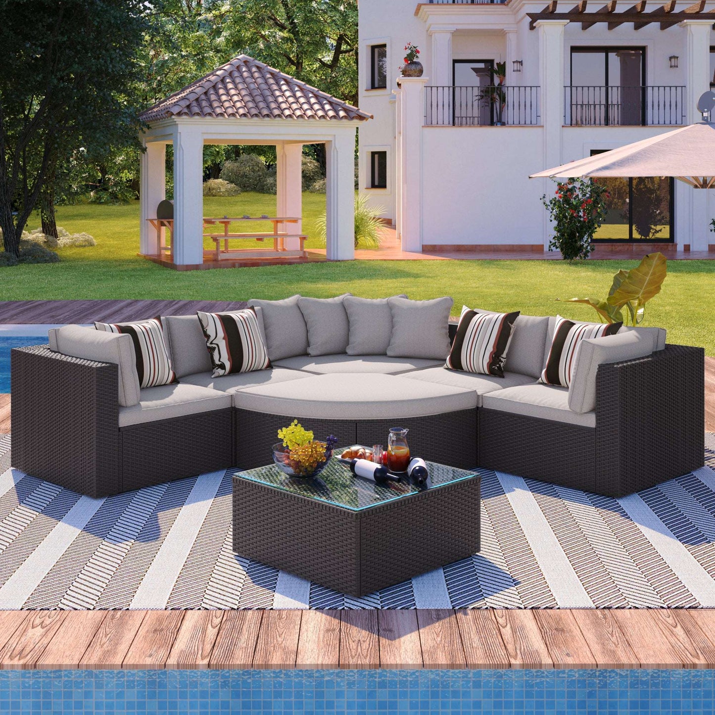 Brown wicker outdoor sectional sofa set with light gray cushions, striped pillows, and glass table