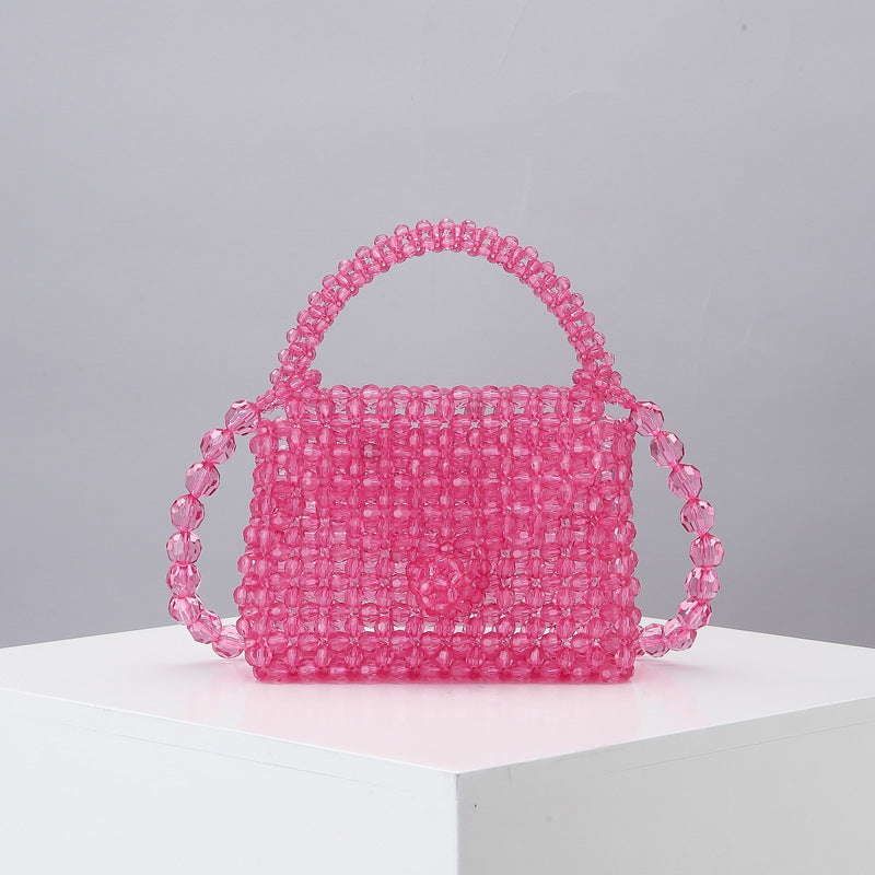 Pink beaded mini tote bag with arched top handle and woven mesh bead body