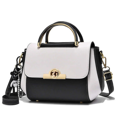 Lightweight crossbody bag with white and black colorblock, top handle, flap closure, gold clasp