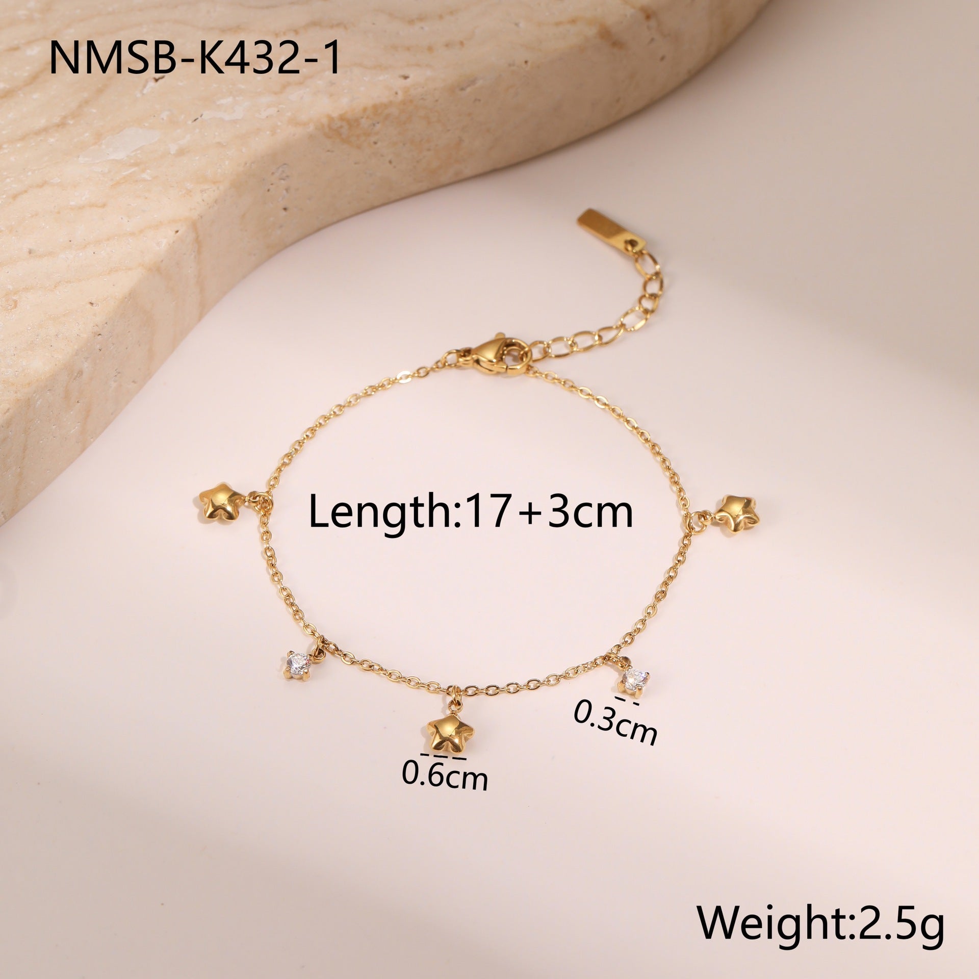 Gold-tone star charm bracelet with crystal dots and dangling star pendants
