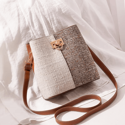 Two-tone textured bucket bag in cream and retro brown with gold clasp, brown crossbody strap