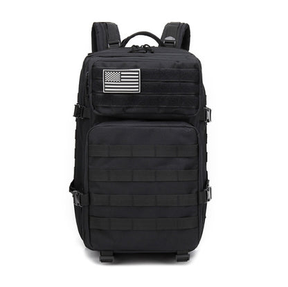 Black tactical backpack with front padding panels, top handle, and rectangular flag patch