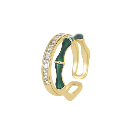 Gold-tone open ring with green enamel centerpiece and zircon stones