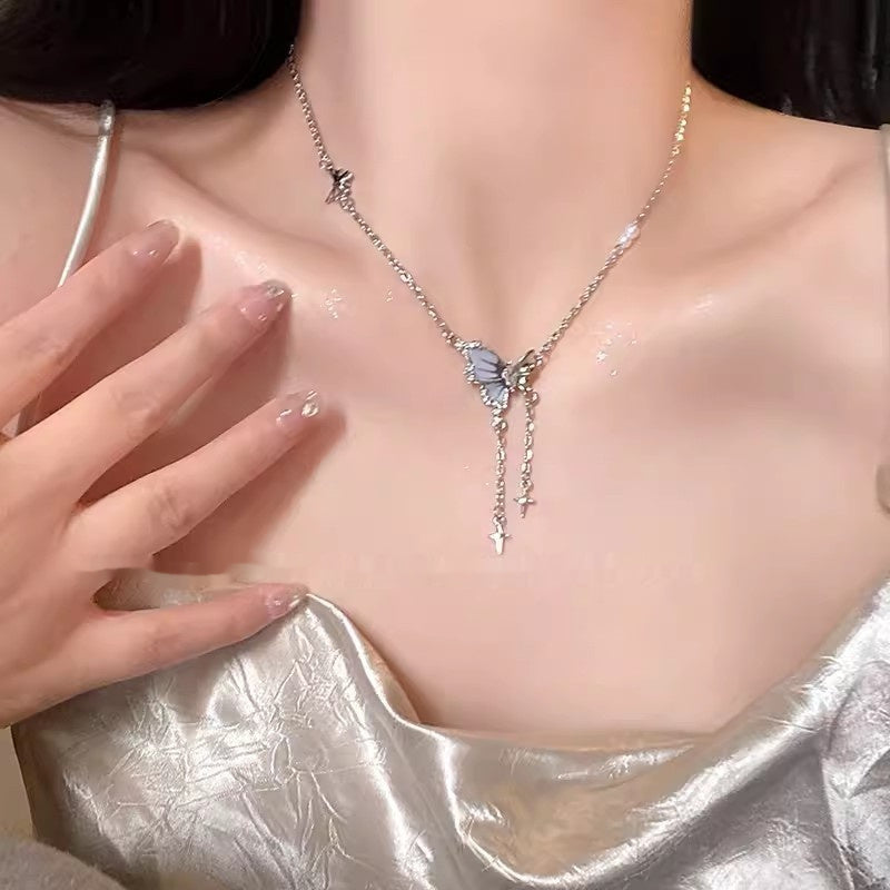 Butterfly cross pendant necklace with layered chain and small dangling charms