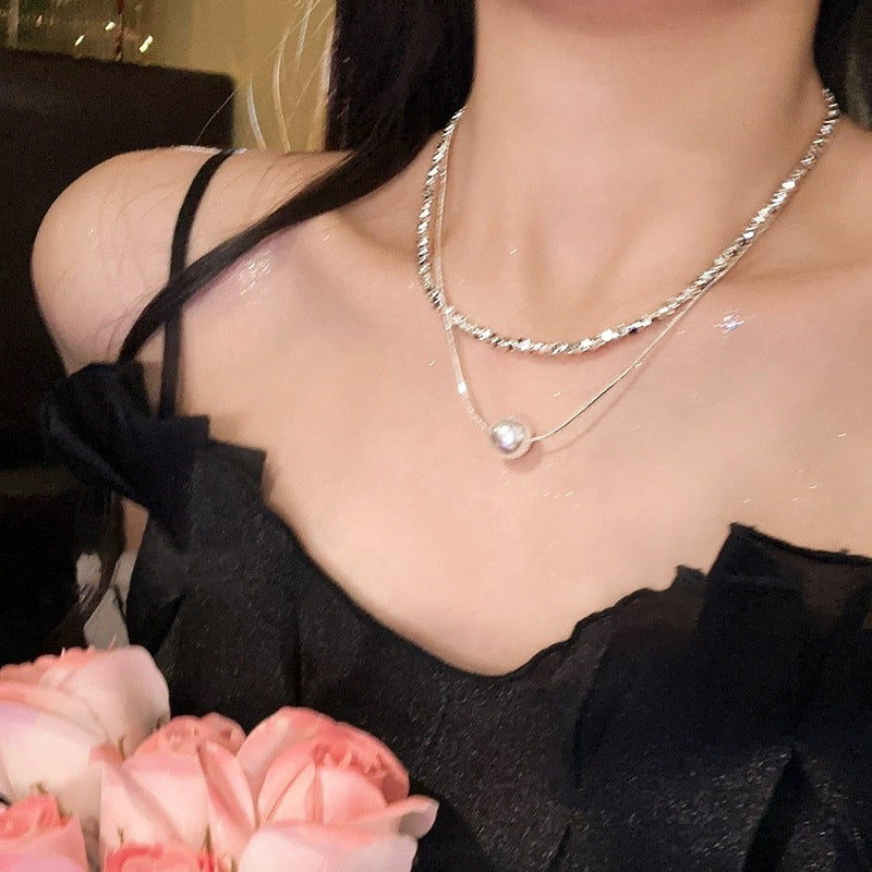 Butterfly pearl necklace with layered silver-tone chain and small pearl drop charm