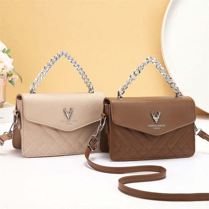 Quilted mini crossbody bag in beige and brown with silver chain straps and flap fronts.