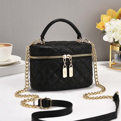 Black quilted fashion tote with chain crossbody strap and short handle, double zip pulls