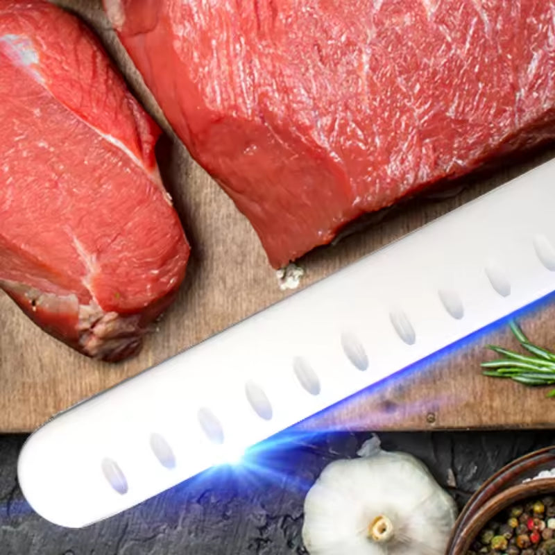 Carving knife slicing raw steaks, white dimpled blade with blue edge glow
