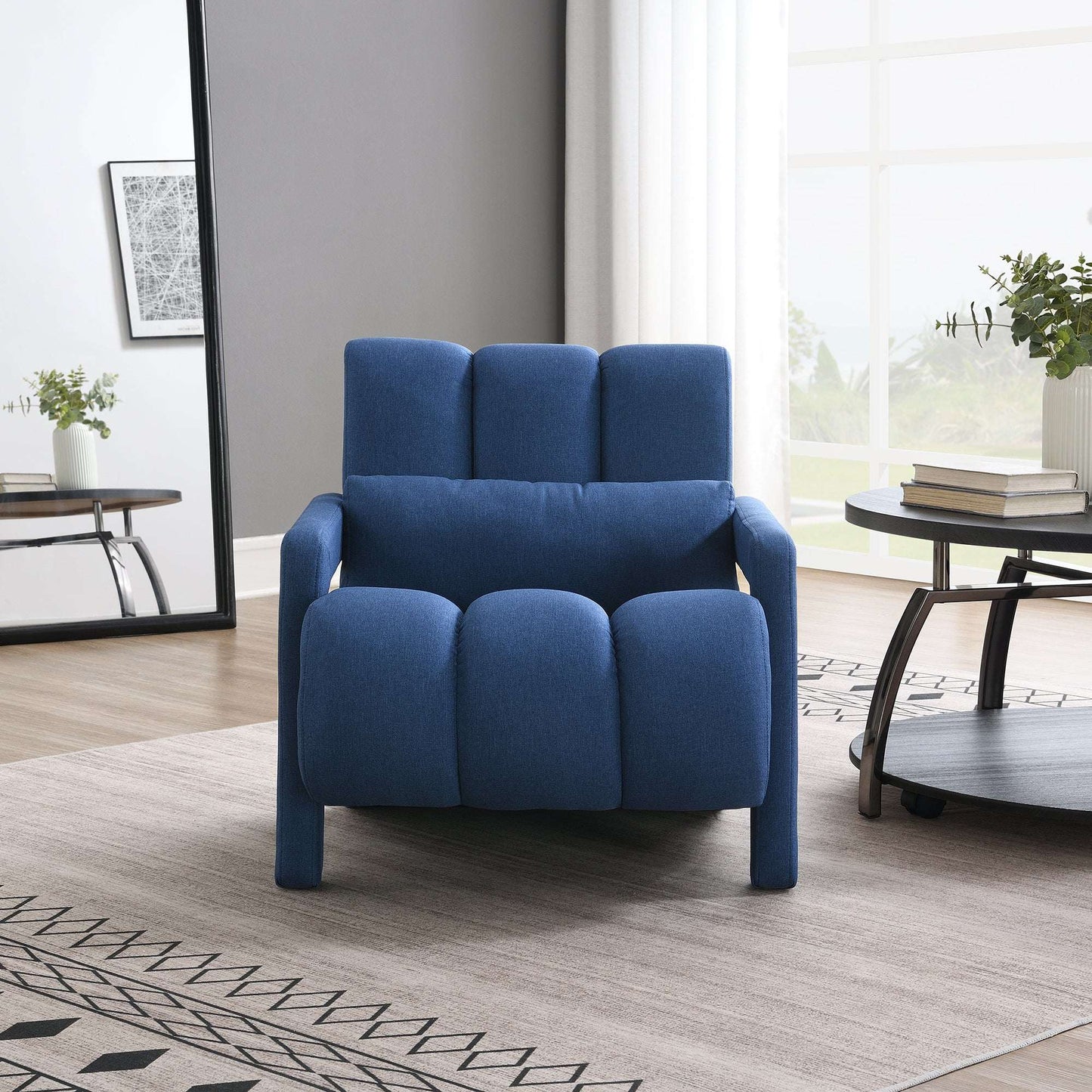 Dark blue upholstered accent chair with plump seat cushions and short arms
