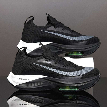 A pair of men's sports shoes with black, green, and gray colors featuring a lace-up closure and a thick sole.