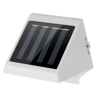 White solar stair light angled close-up, showing solar panel bars and LED opening