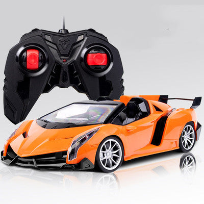 RC racing car model in orange with remote controller, angled front view