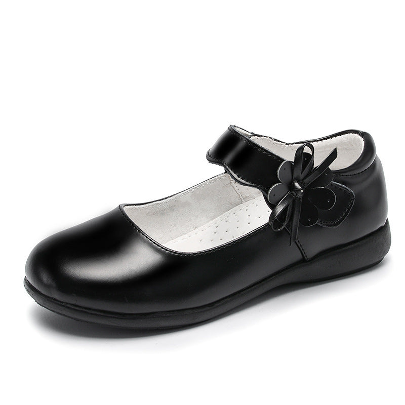 Black leather flat shoes with ankle strap and large flower bow detail, low sole