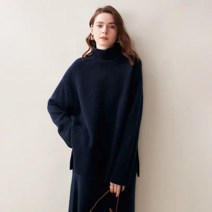 Woman wearing a dark blue sweater against a plain background