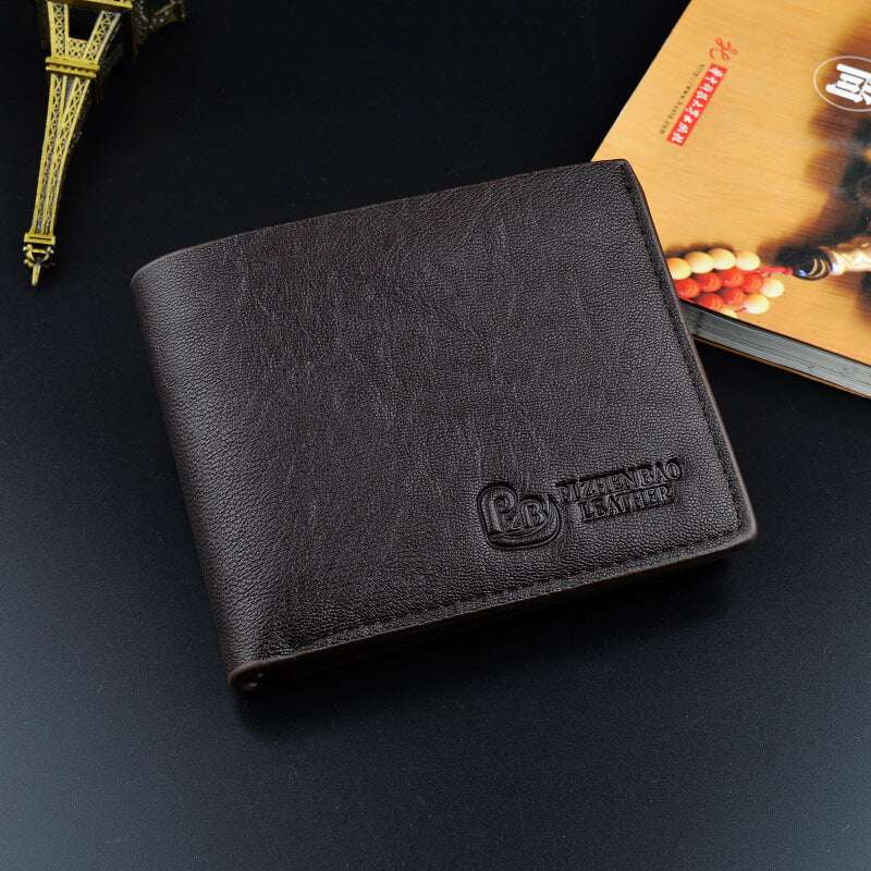 Slim short leather wallet in black with embossed logo on the front