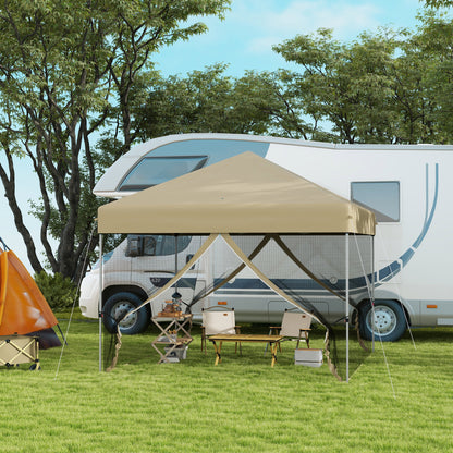 Khaki folding camping chair with canopy-style umbrella poles nearby