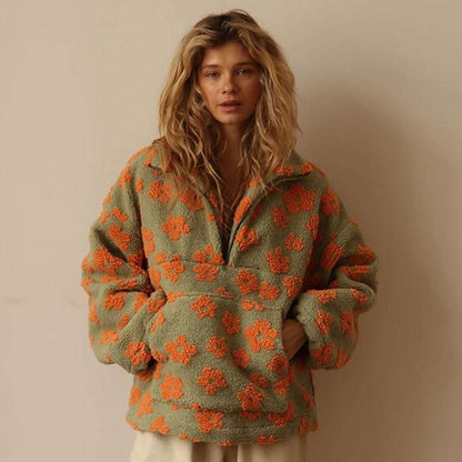 Woman wearing a green and orange floral-patterned jacket against a beige background