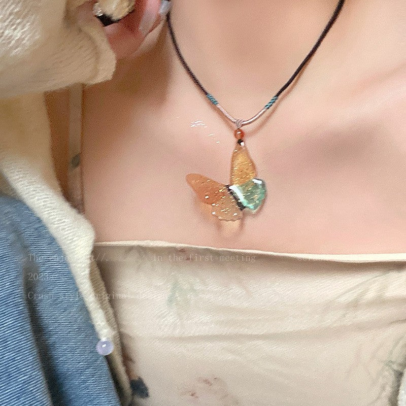 Butterfly pearl necklace with multi-color butterfly pendant and pearl bead detail