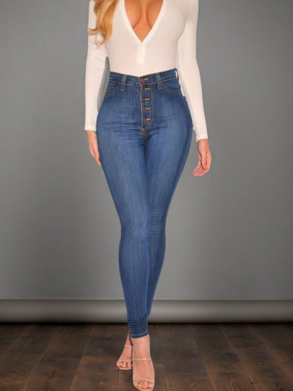 Women’s mid-blue high-waisted buckle jeans, front view with dark button fly and fitted legs