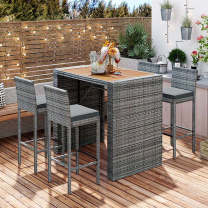 Outdoor patio wicker bar set with gray wicker bar table and four matching stools