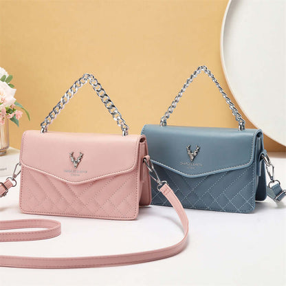 Pair of quilted mini crossbody bags with chain straps, showing pink and blue flap fronts.