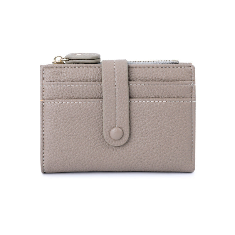 Gray short wallet with card slots, snap button tab, and small coin zipper pocket