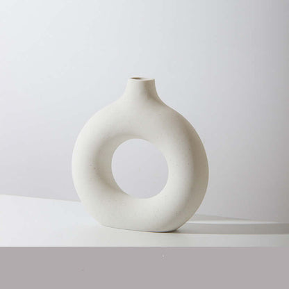 Light ceramic vase with circular cutout, rounded body and short neck