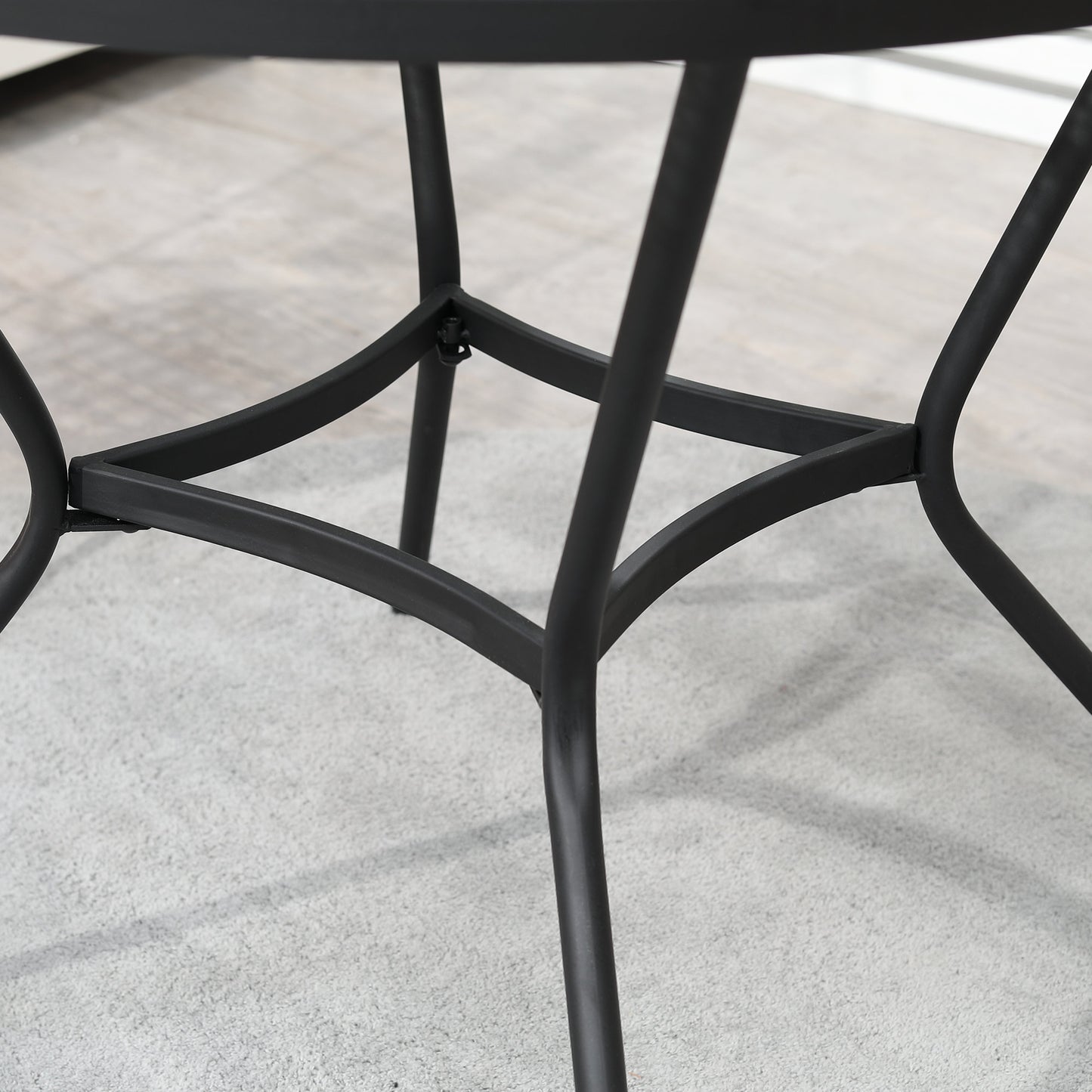 Black round bistro table leg frame with curved cross supports and angled feet