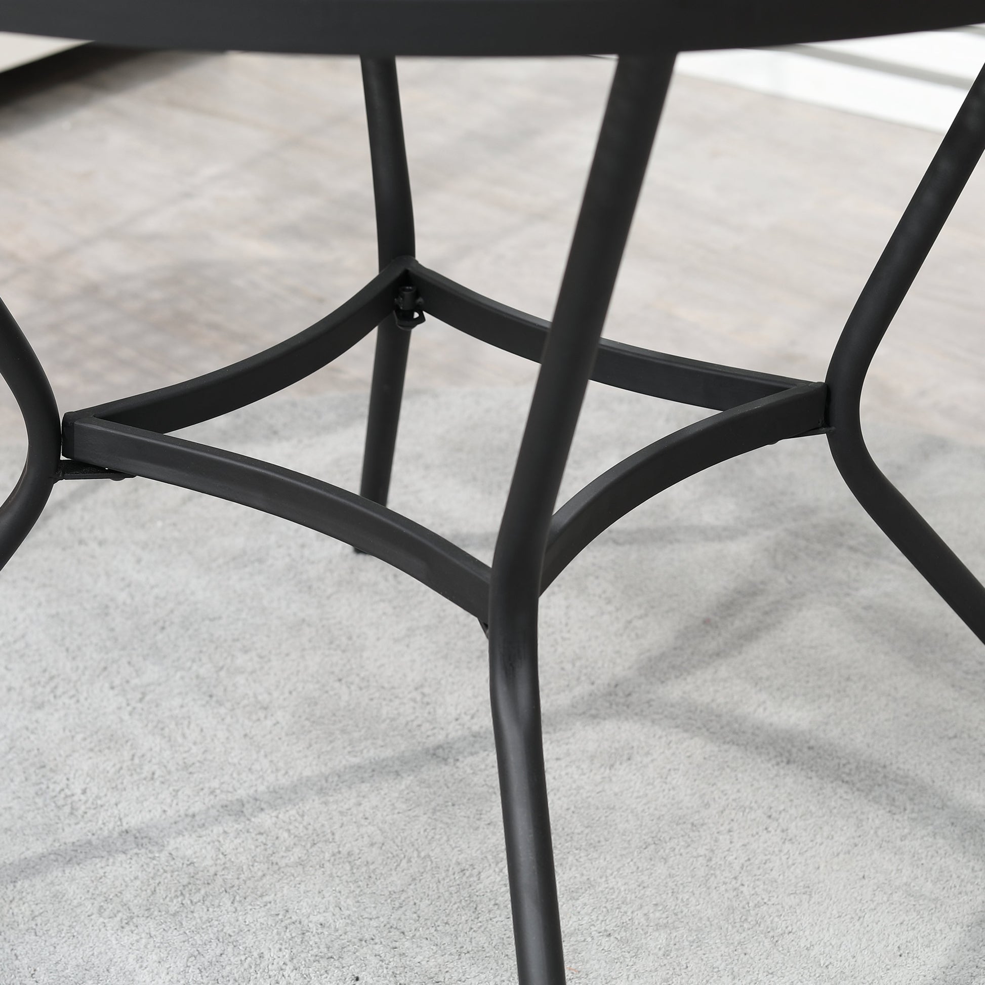 Black round bistro table leg frame with curved cross supports and angled feet