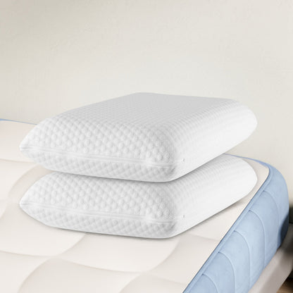 Stacked white memory foam cervical pillows with a blue base layer