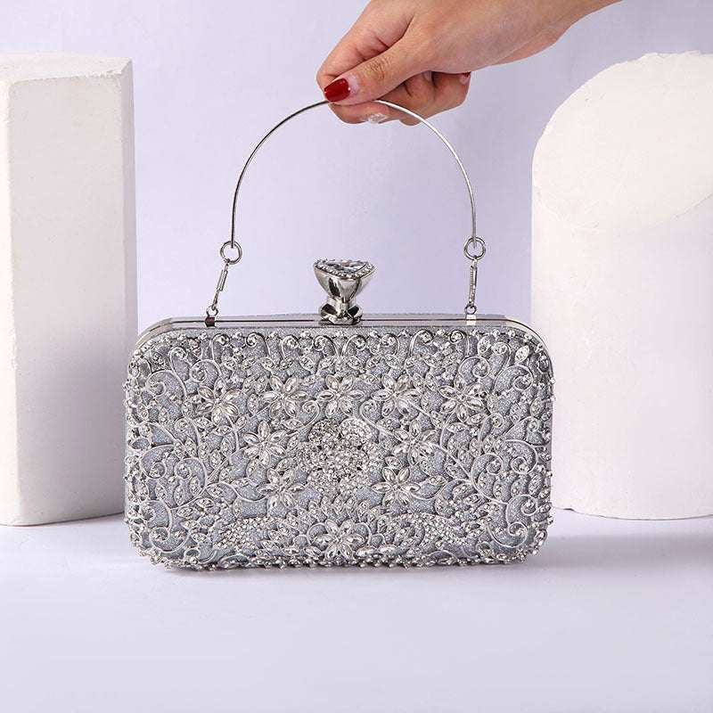Silver rhinestone evening handbag with curved top handle and ornate frame clasp