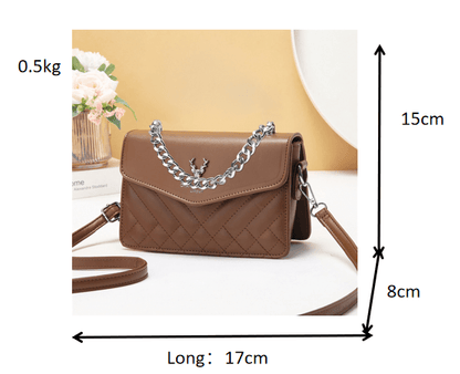 Quilted mini crossbody bag in brown with silver chain strap and flap front with snap.