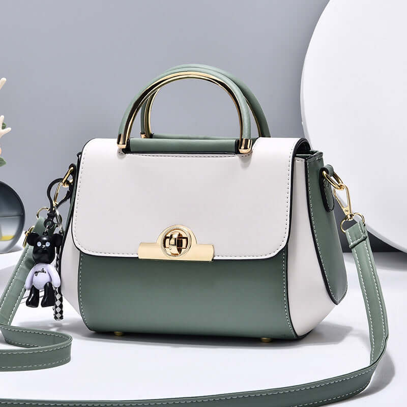 Lightweight crossbody bag with white and green colorblock, top handle, flap, gold clasp