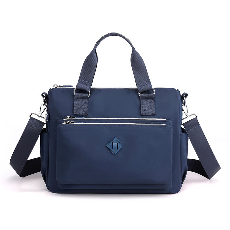 Waterproof nylon one-shoulder bag, dark blue, front view with zip pocket
