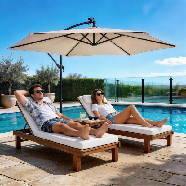 Khaki hanging patio umbrella over outdoor lounge chairs by a pool