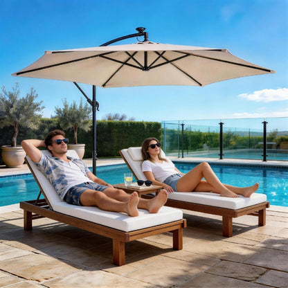 Khaki hanging patio umbrella over outdoor lounge chairs by a pool