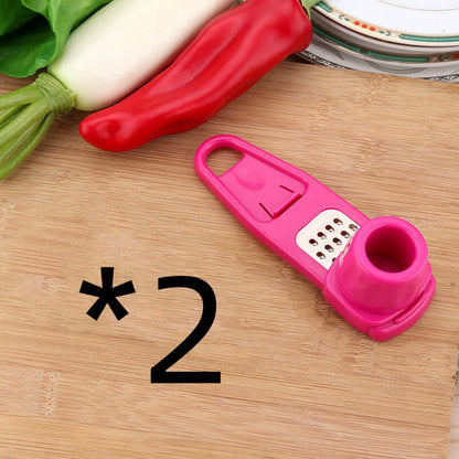 Light green and pink manual garlic mashers with grater plates and open handle ends