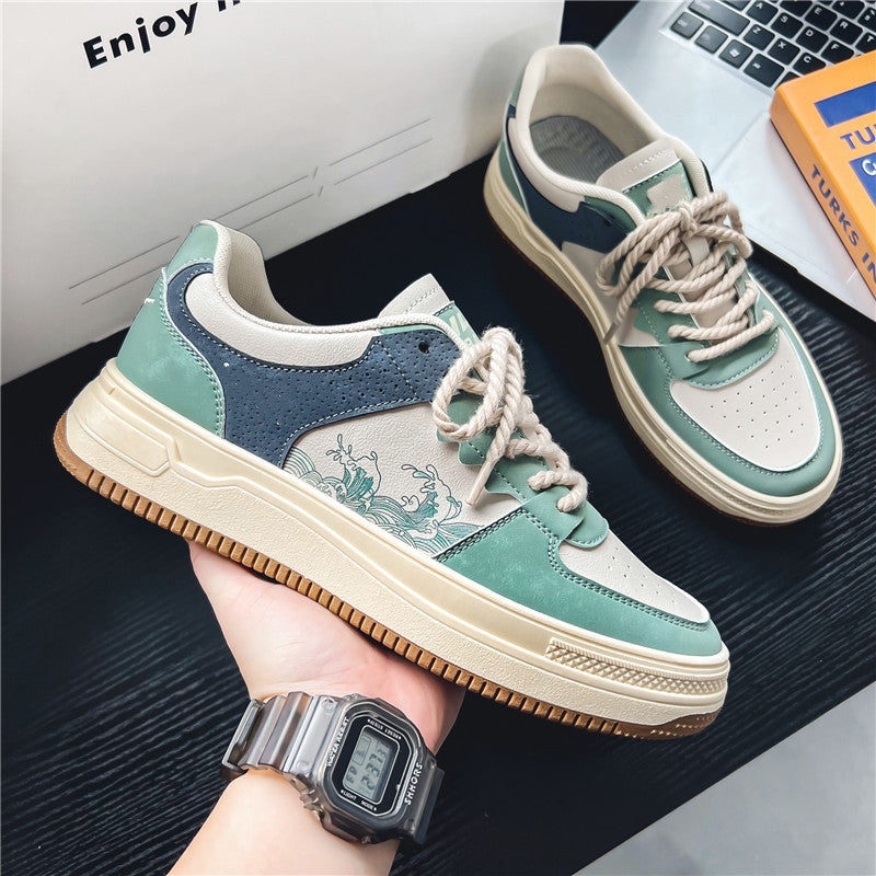Low-top sneakers with teal and navy suede, beige patterned side, and white lace-up