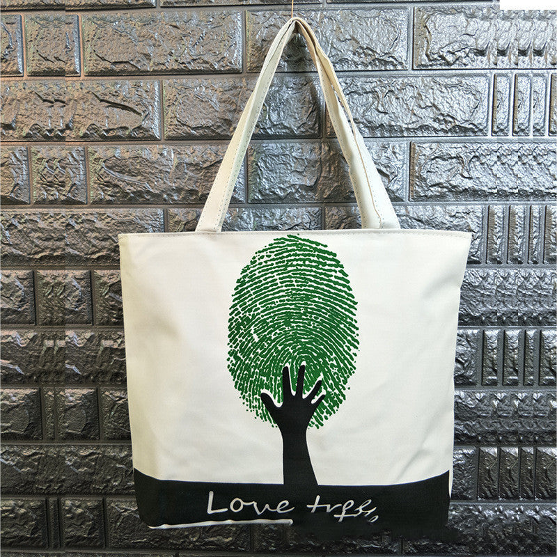 Canvas shoulder bag with green tree fingerprint graphic and “Love tree” text