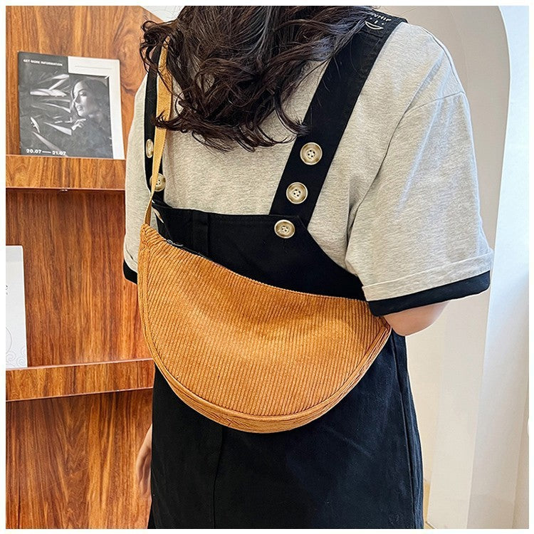 Large dumpling crossbody bag, tan corduroy with black strap and gold buttons