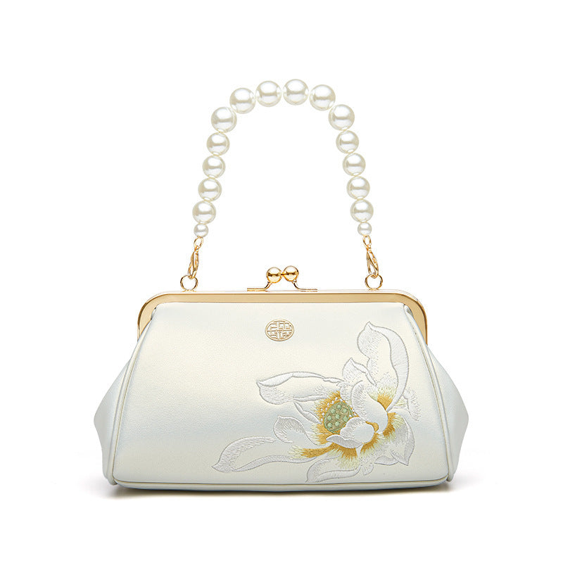 Pearlescent white small clutch bag with embroidered floral design and pearl beaded handle