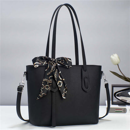 Black tote handbag with top handles, front zipper pocket, and shoulder strap.