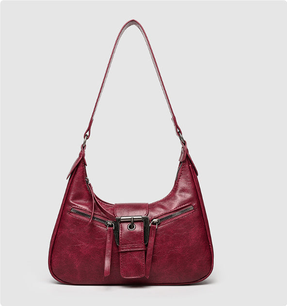 Red one-shoulder underarm bag with front buckle and zip pocket accents