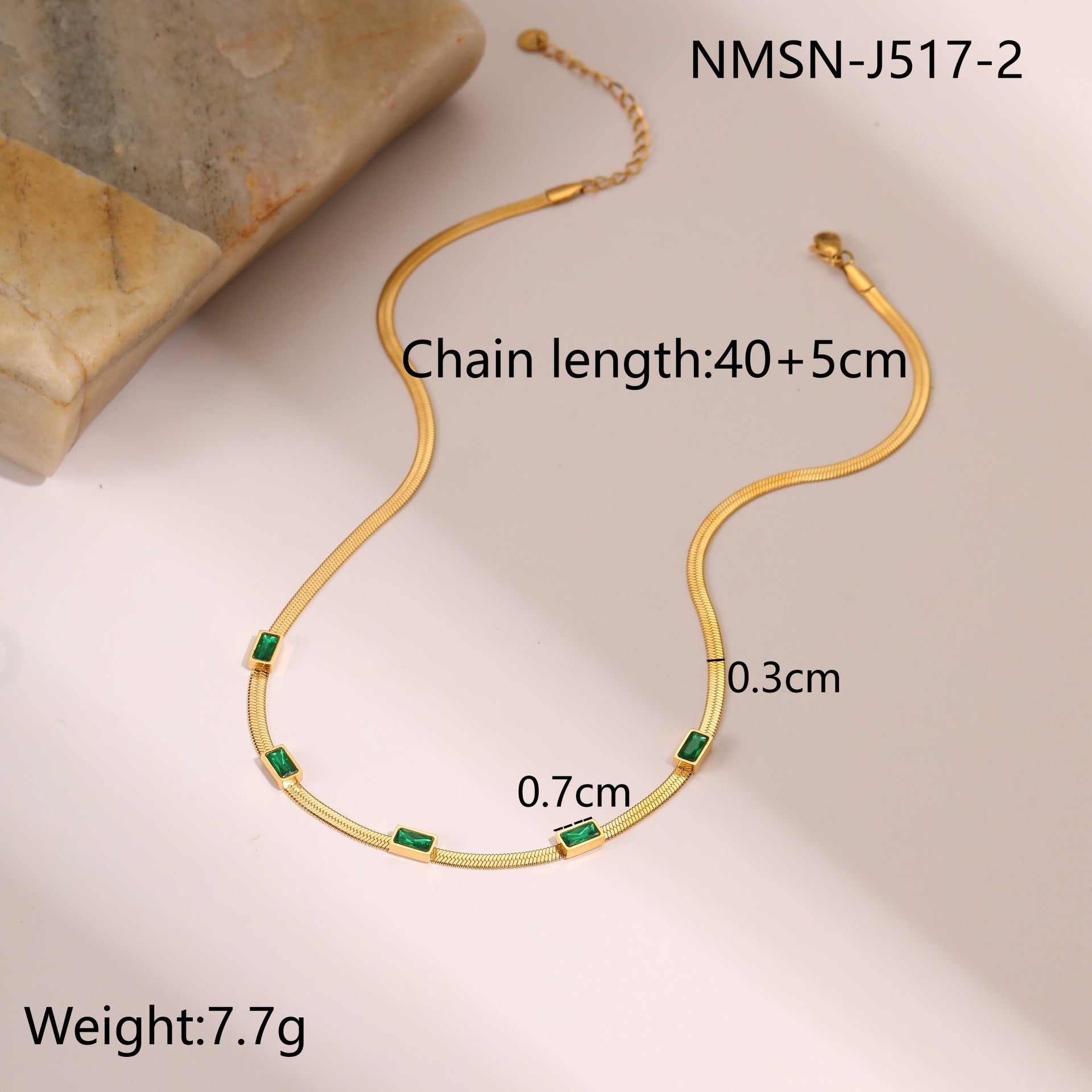 Gold snake chain necklace with square zircon links and green accents