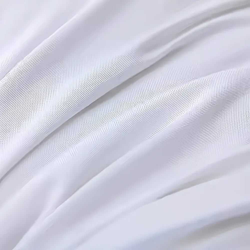 White pillow cover close-up with subtle stitched stripes and seam lines