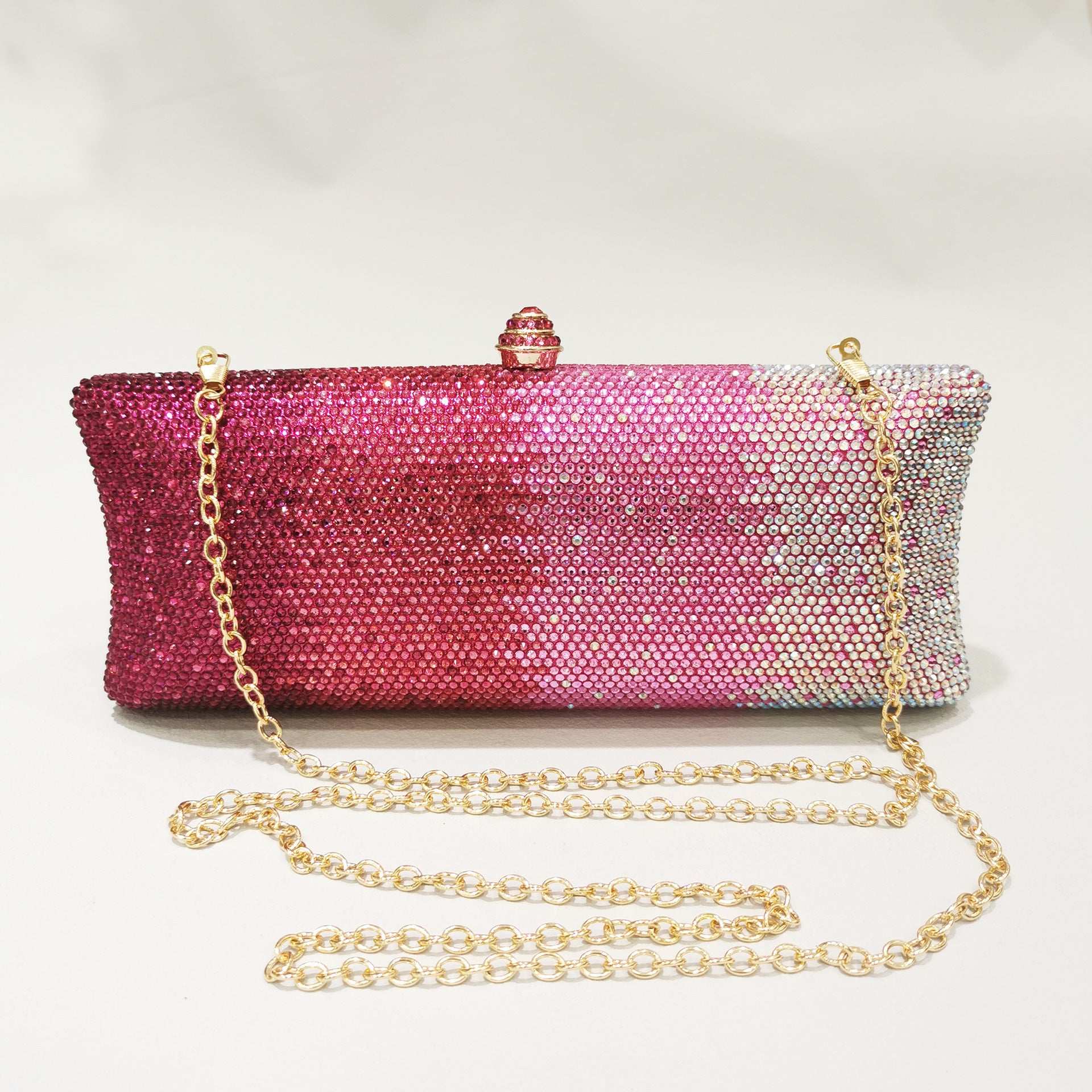 Rhinestone gradient dinner clutch with top clasp and gold shoulder chain, pink to purple