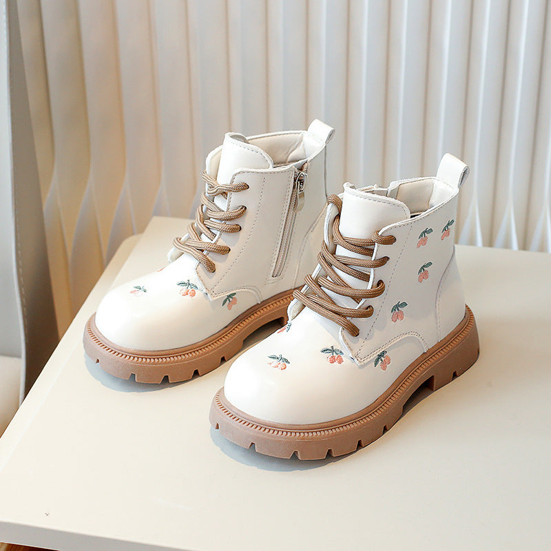 Cream girls ankle booties with lace-up closure, embroidered floral details, and tan sole