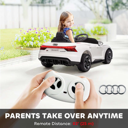 White kids convertible ride-on car with steering wheel; child seated while holding remote