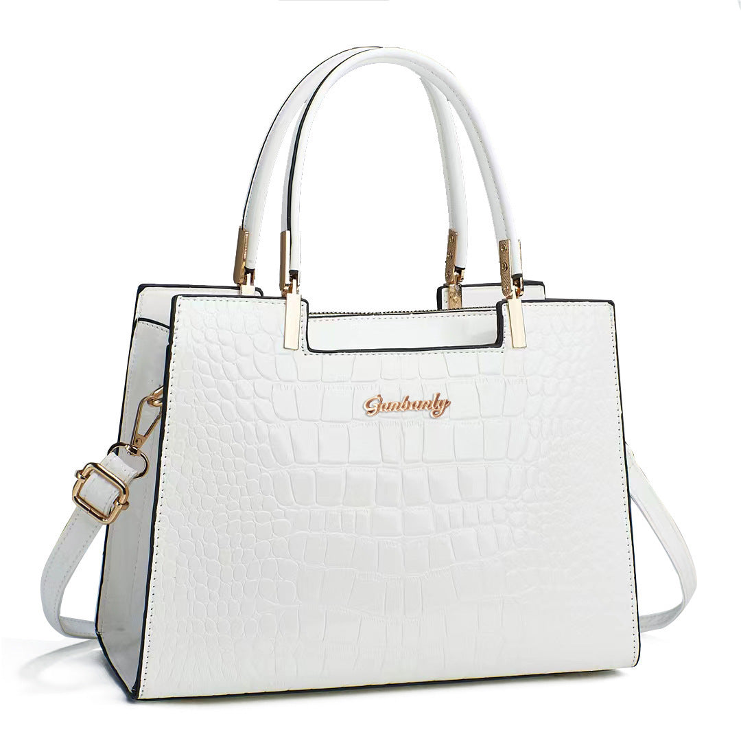 White croc-texture tote with top handles and crossbody strap, structured rectangular bag